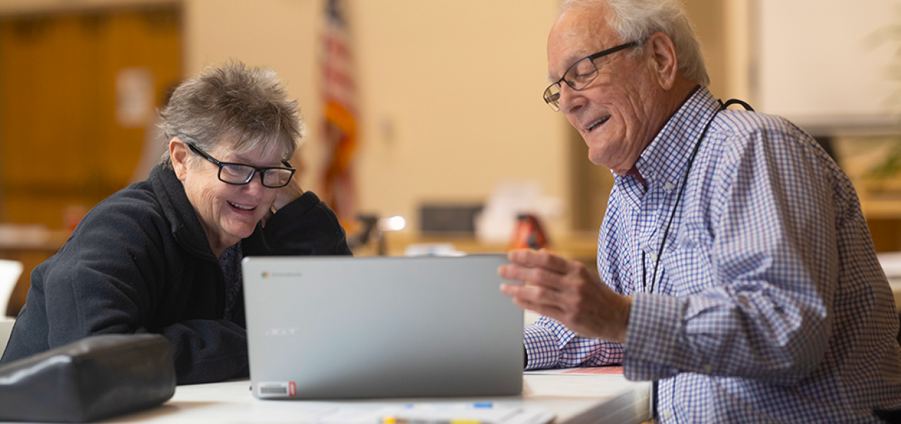 AARP volunteer tax preparer working with client